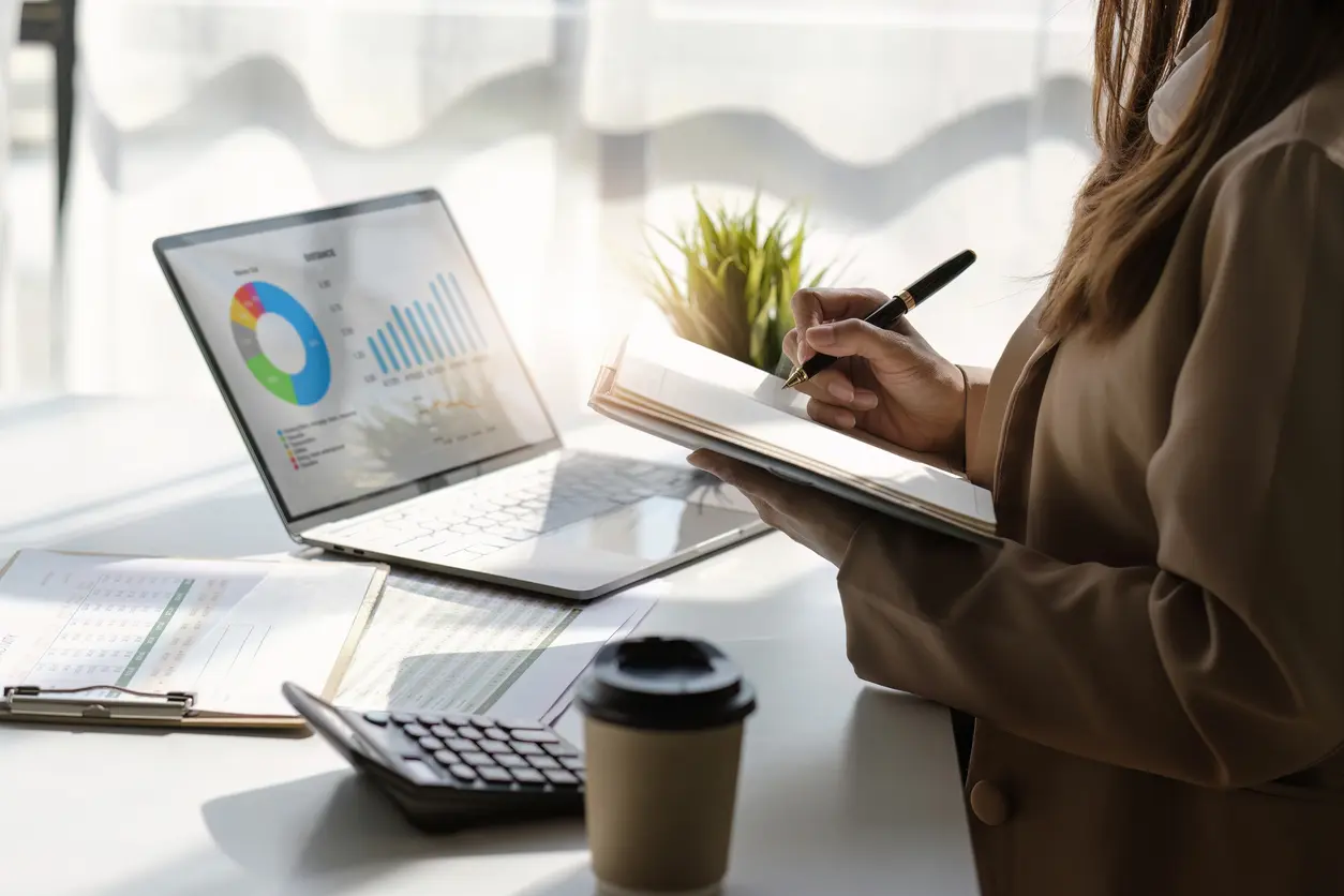 woman taking notes at desk