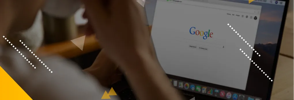 person drinking coffee looking at Google search screen on their laptop