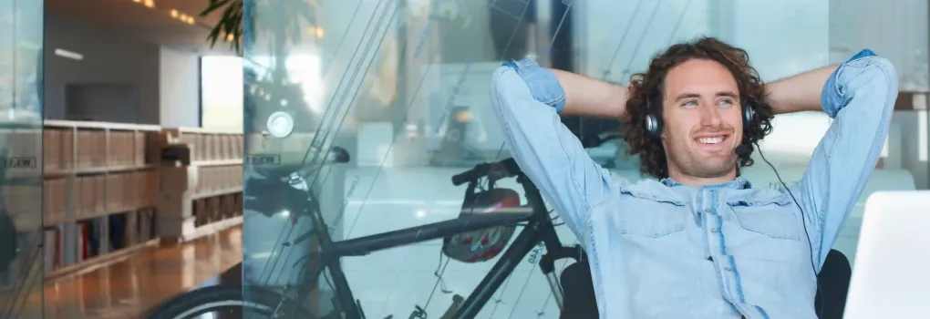 man at desk wearing headphones