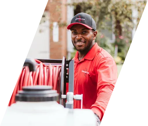 Frontline Technician standing next to truck