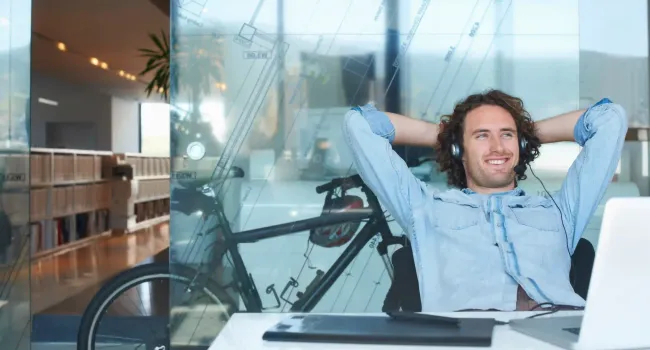 man at desk wearing headphones