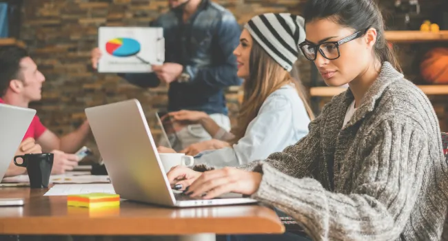 in office meeting woman on laptop