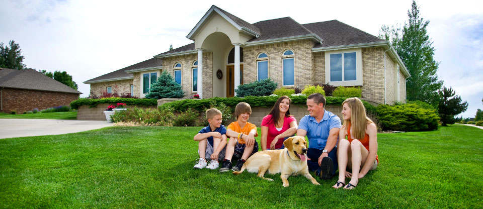 family sitting in a lawn